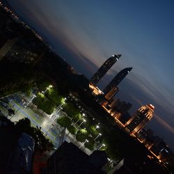 Aerial view of illuminated cityscape against sky at night