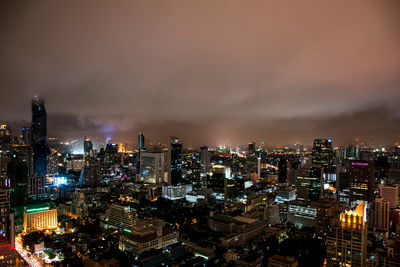 High angle view of illuminated city buildings against sky