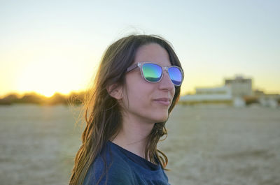 Portrait of man wearing sunglasses against sky during sunset