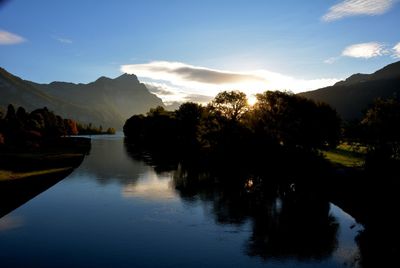 Scenic view of lake against sky at sunset