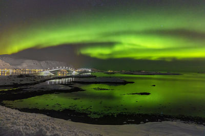 Scenic view of river against sky at night