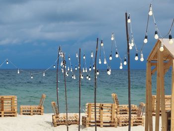 Sailboats on beach against sky