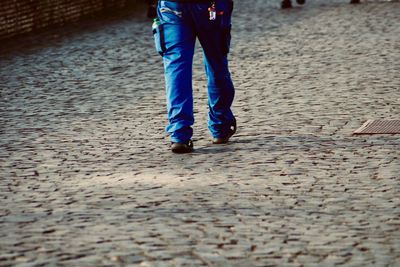 Low section of man standing on street