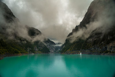 Scenic view of lake and mountains against sky