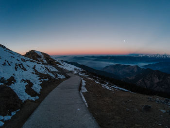 Scenic view of snowcapped mountains against clear sky during winter