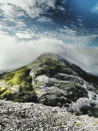 Scenic view of mountains against cloudy sky