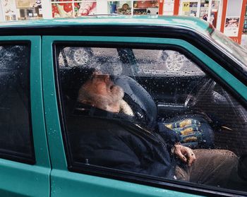 Reflection of man in car