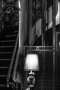 Close-up of electric lamp hanging on window