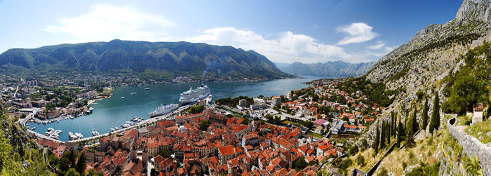 Panoramic shot of townscape by sea against sky