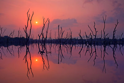 Scenic view of lake against romantic sky at sunset