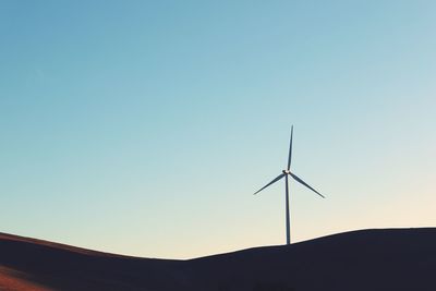 Low angle view of wind turbine against clear sky