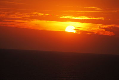 Scenic view of sea against orange sky