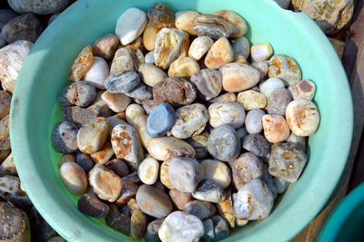 High angle view of pebbles in container