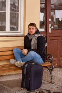Portrait of young man sitting on seat