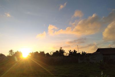 Scenic view of sunset over field