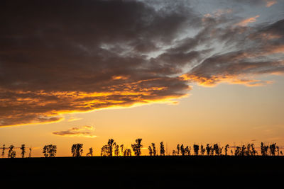 Silhouette landscape against sky during sunset