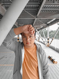Portrait of teenage boy standing on ceiling