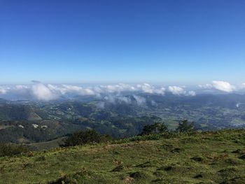 Scenic view of mountains against blue sky