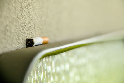 Close-up of cigarette on water