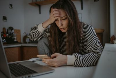 Young woman using laptop at home