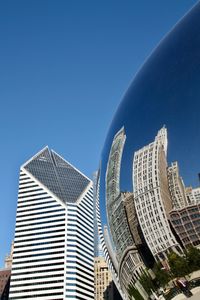 Low angle view of modern buildings against clear blue sky