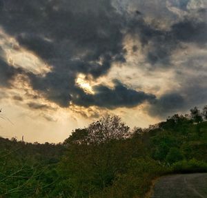 Scenic view of grassy field against cloudy sky