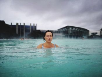 Portrait of smiling man swimming in pool