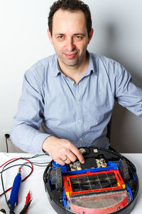 Portrait of man holding mobile phone