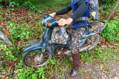 Villagers drive old motorcycles to collect turtle liver mushrooms in the fores