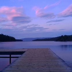 Pier on lake at sunset