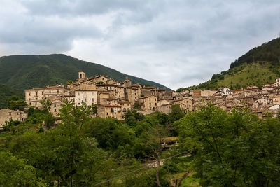 Panoramic view of buildings and mountains against sky