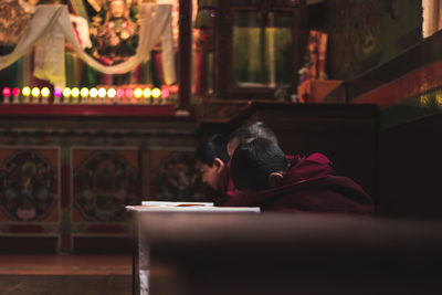 Rear view of a man sitting in temple