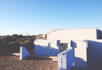 Houses against clear blue sky