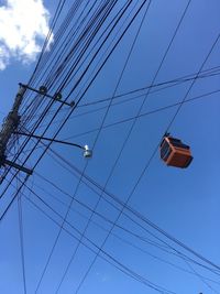 Low angle view of cables against sky