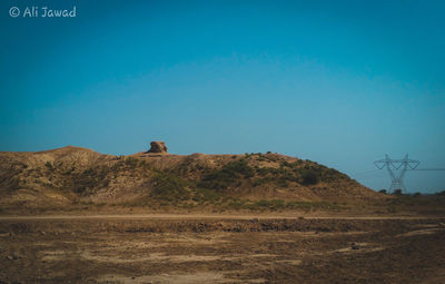 Scenic view of field against clear blue sky