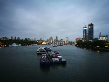 Boats sailing on river in city