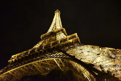 Low angle view of illuminated building against sky at night