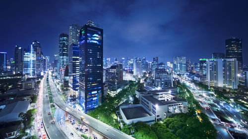 High angle view of illuminated buildings in city at night