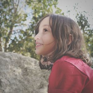 Portrait of a smiling young woman looking away