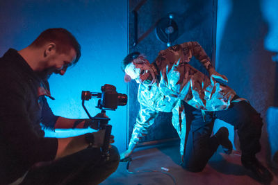 People photographing illuminated stage