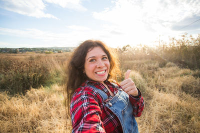 Portrait of smiling young woman on field