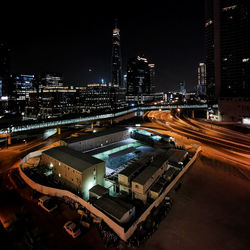 High angle view of illuminated city street and buildings at night