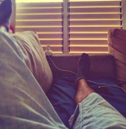 Low section of man sitting on floor