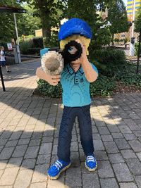 Full length of child standing on footpath