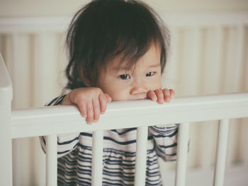 Close-up of cute baby girl at home