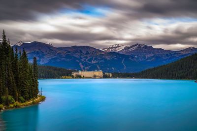 Scenic view of sea and mountains against sky