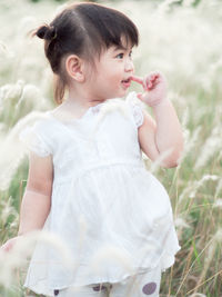 Cute girl sitting on field