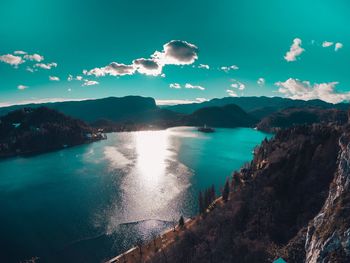 Scenic view of sea and mountains against sky