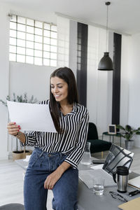 Young woman sitting on table