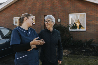 Home caretaker going on walk with senior woman